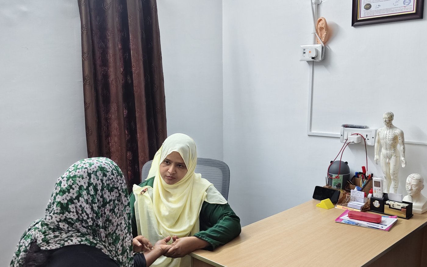 Dr. M. Mehraj Abdullah, M.D (Acu) in clinical consultation at Balance & Bliss