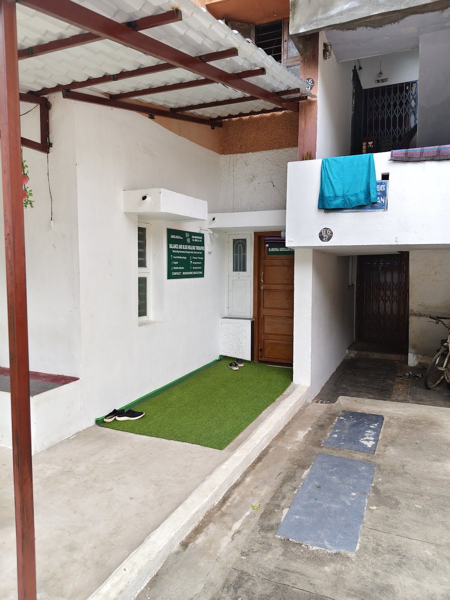 Clinic building exterior at Housing Board Colony, K.K Nagar with dedicated patient vehicle parking